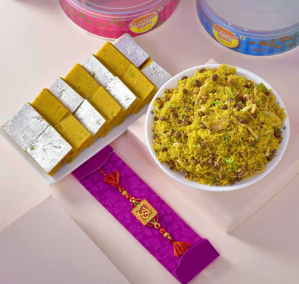 Blessed Om Rakhi Combo With Flavorful Dalmoth N Kesar Kaju Barfi